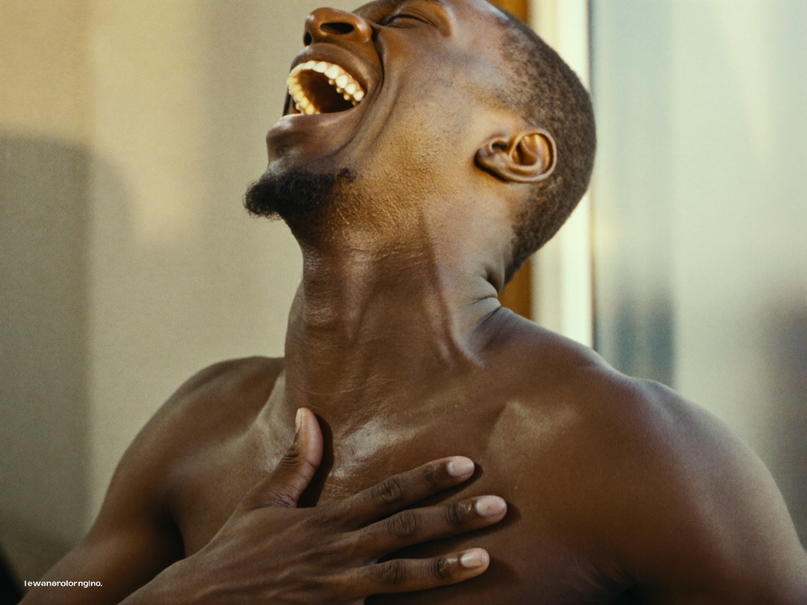 A man beaming with relief by a bright window